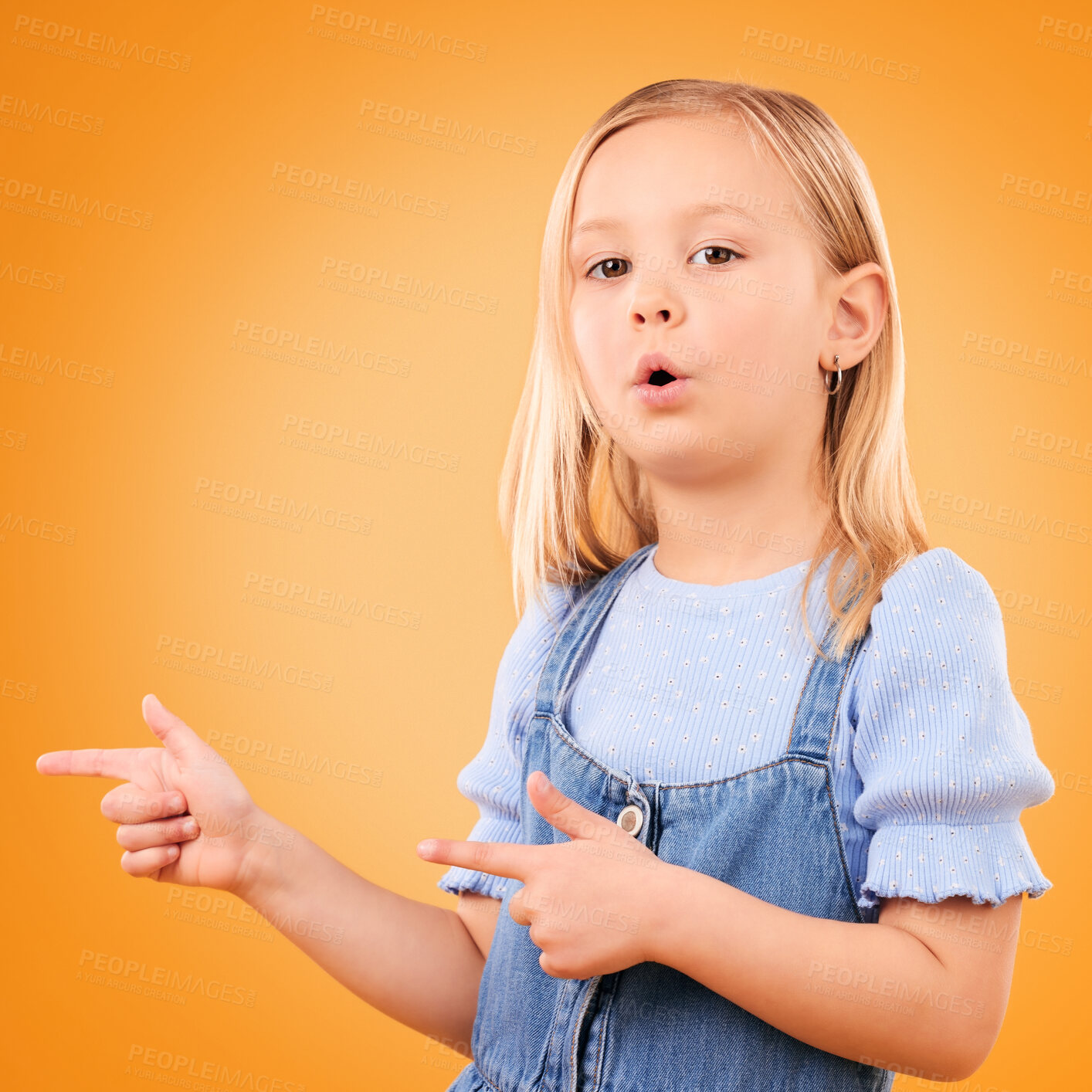 Buy stock photo Child, portrait and girl with finger gun in studio for advertising, announcement or promotion. Young kid on orange background for hand gesture, pointing or sign for direction, attention or marketing