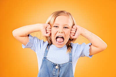 Portrait, girl and kid with anger, screaming or emoji with emotion on a yellow studio background. Face, person or model with stress, frustrated or shouting with a child, facial expression or attitude