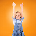 Excited, celebration and girl child with arms up in studio for success, winner or happy on orange background. Yes, news and kid with hands, smile and celebrating achievement, victory or announcement