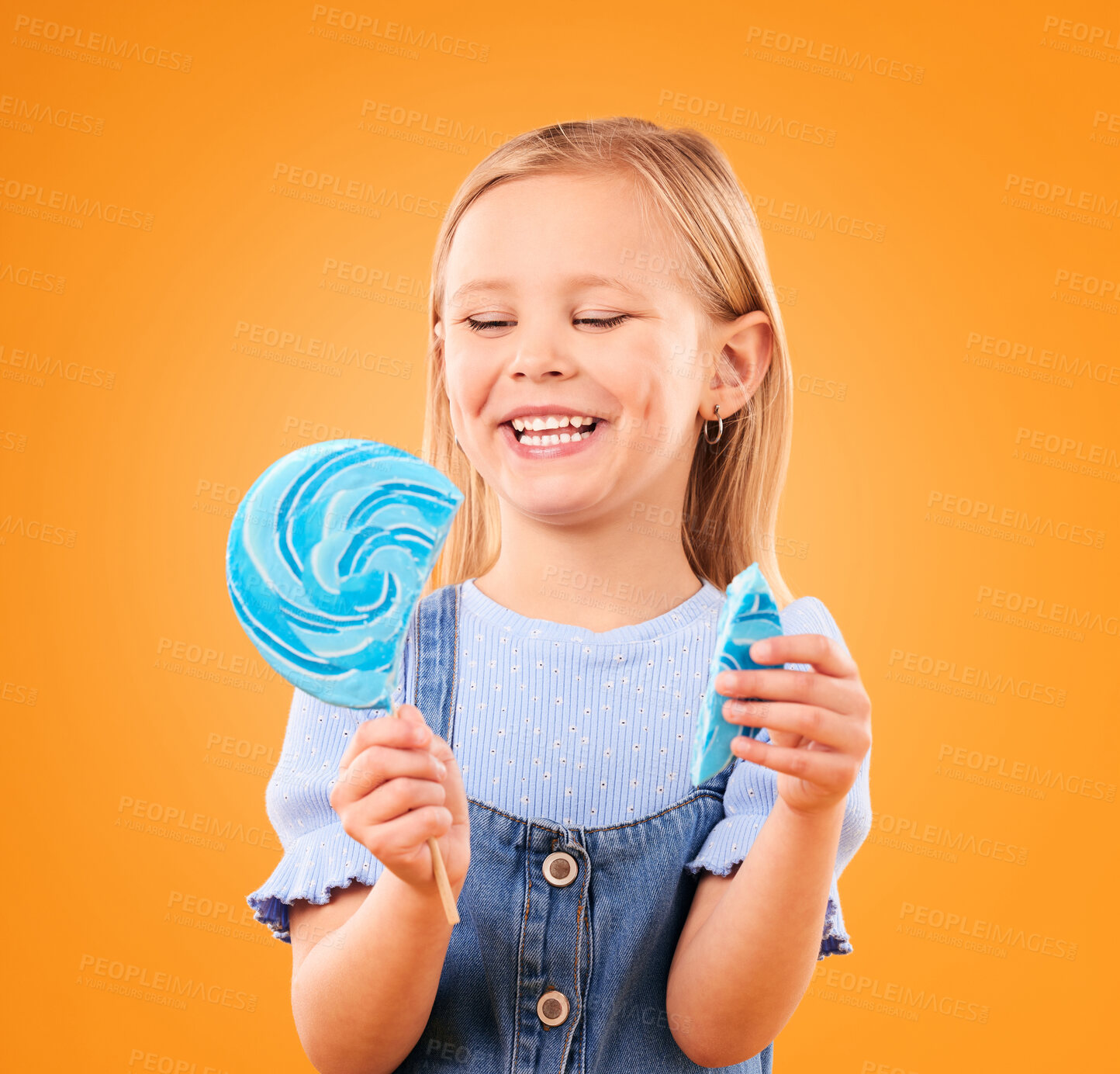 Buy stock photo Lollipop, candy and a child laughing in studio for sweet tooth, color spiral or sugar for energy. Face of happy girl kid on orange background for funny snack or thinking of dessert or unhealthy food
