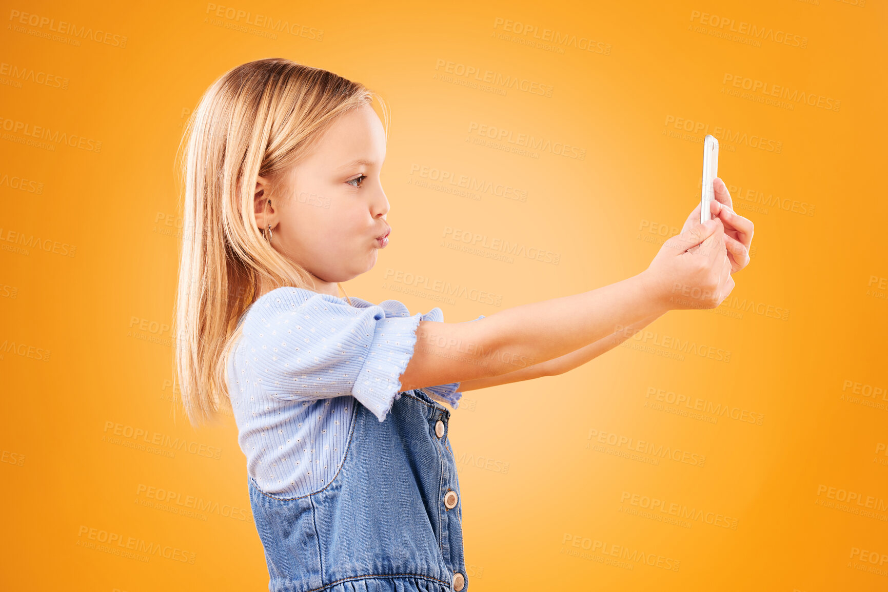 Buy stock photo Phone, selfie or profile of kid in studio with confidence or mockup space in photograph memory. Pout, orange background or young girl child taking picture online on a social media app on internet