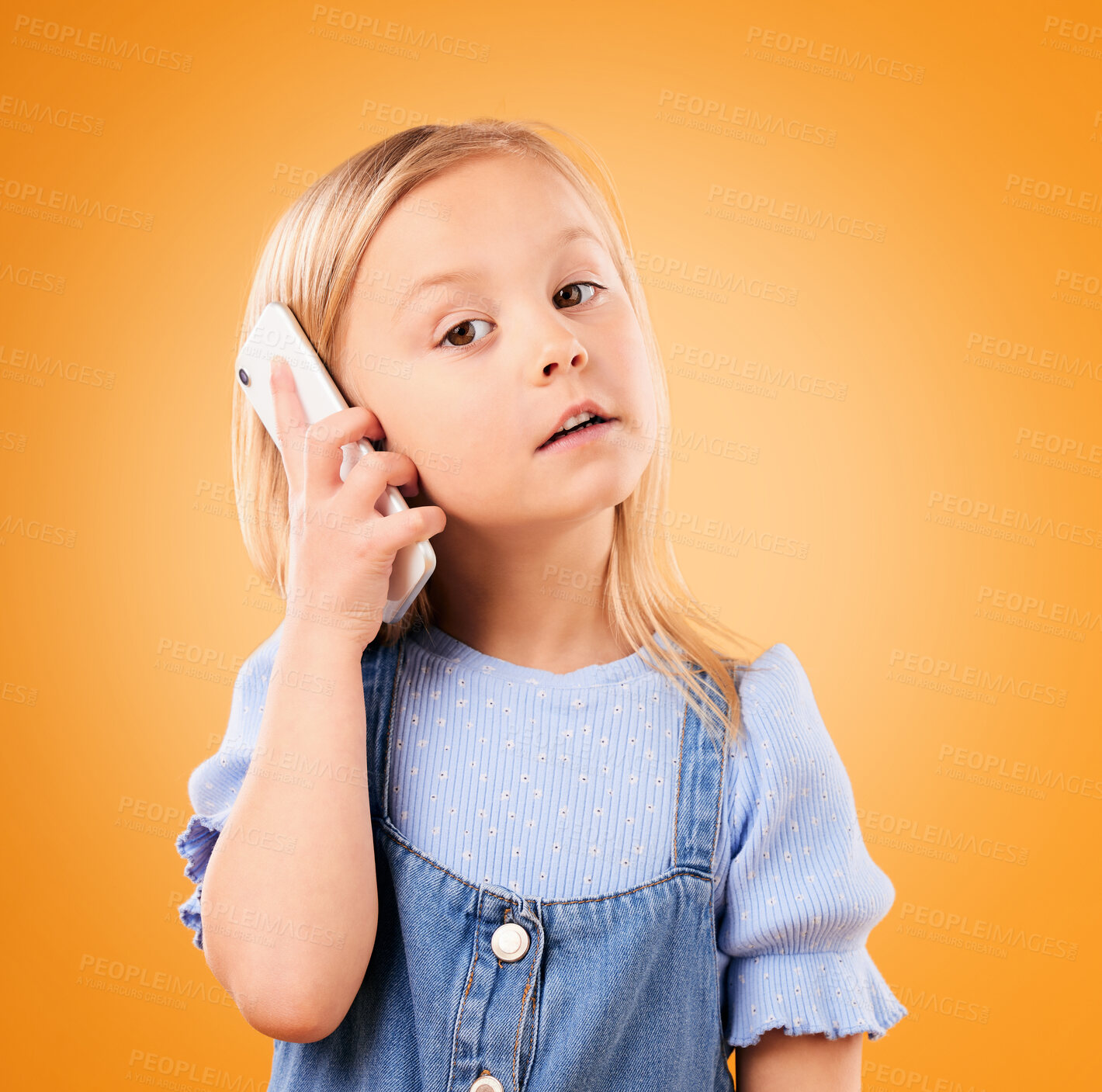 Buy stock photo Portrait of child, phone call and talking in studio for digital contact, communication or mobile chat on orange background. Young girl kid speaking on smartphone in conversation, discussion and hello