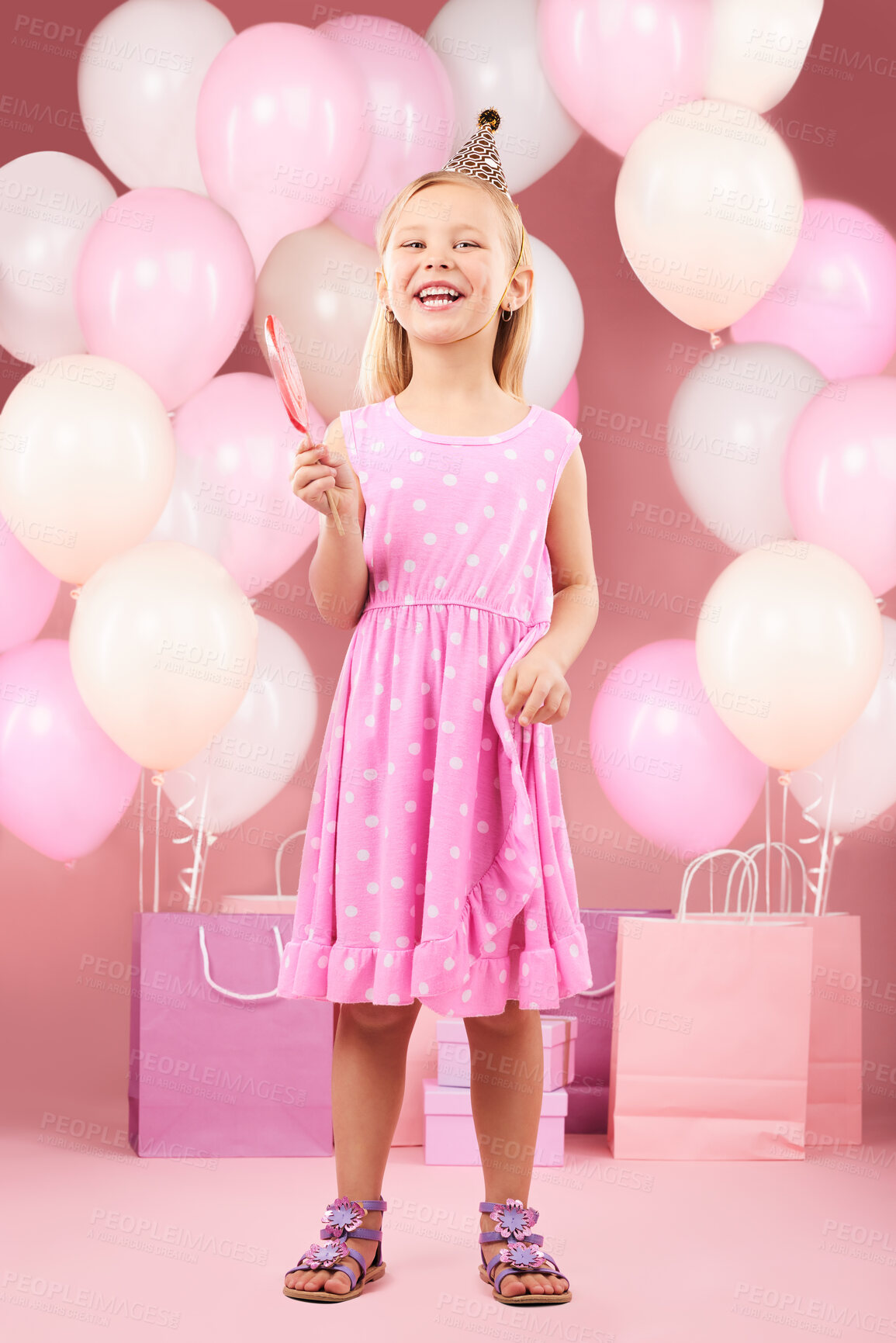 Buy stock photo Balloons, birthday and portrait of girl on pink background for party, celebration and special day. Happy, excited and young child with presents, gift box and lollipop for event decoration in studio