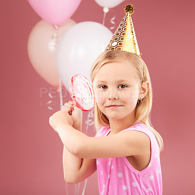 Buy stock photo Girl kid, birthday party and balloons in studio portrait, lollipop and hat for celebration, event and red background. Female child, face and candy with gift, present and decoration to celebrate