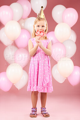 Buy stock photo Balloons, lollipop and portrait of girl in studio for birthday party, celebration and special day. Happy, excited and young cute child smile with candy, sweet treats and dessert on pink background