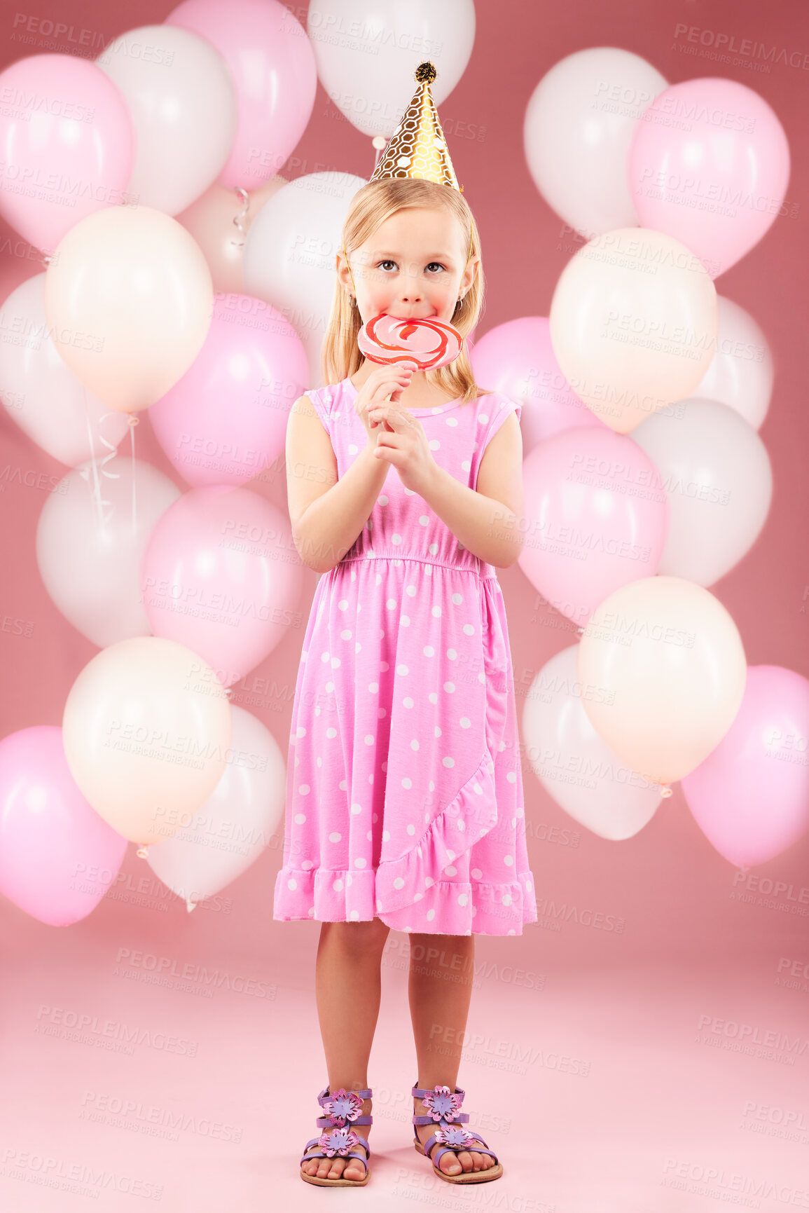 Buy stock photo Balloons, lollipop and portrait of girl in studio for birthday party, celebration and special day. Happy, excited and young cute child smile with candy, sweet treats and dessert on pink background