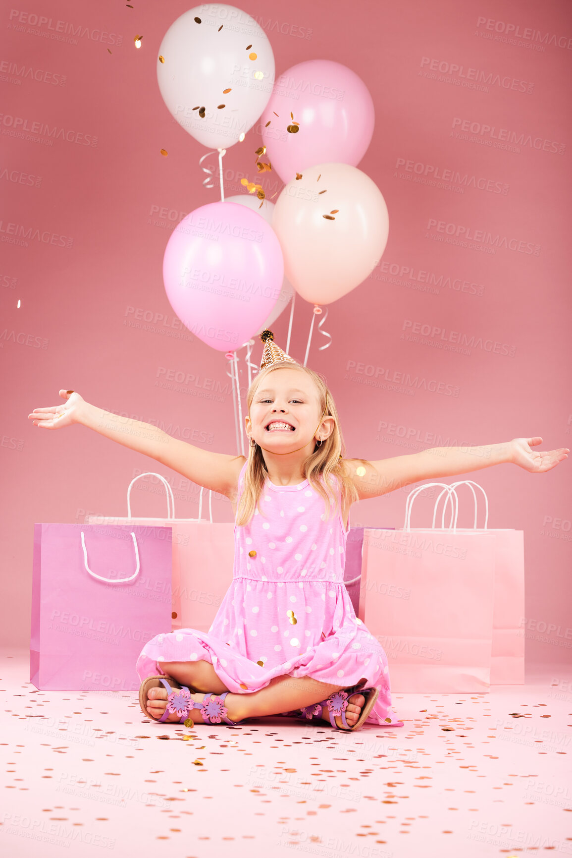 Buy stock photo Balloons, birthday and portrait of excited girl on pink background for party, celebration and event. Happy, confetti and young child with open arms for presents, gift box and decoration in studio