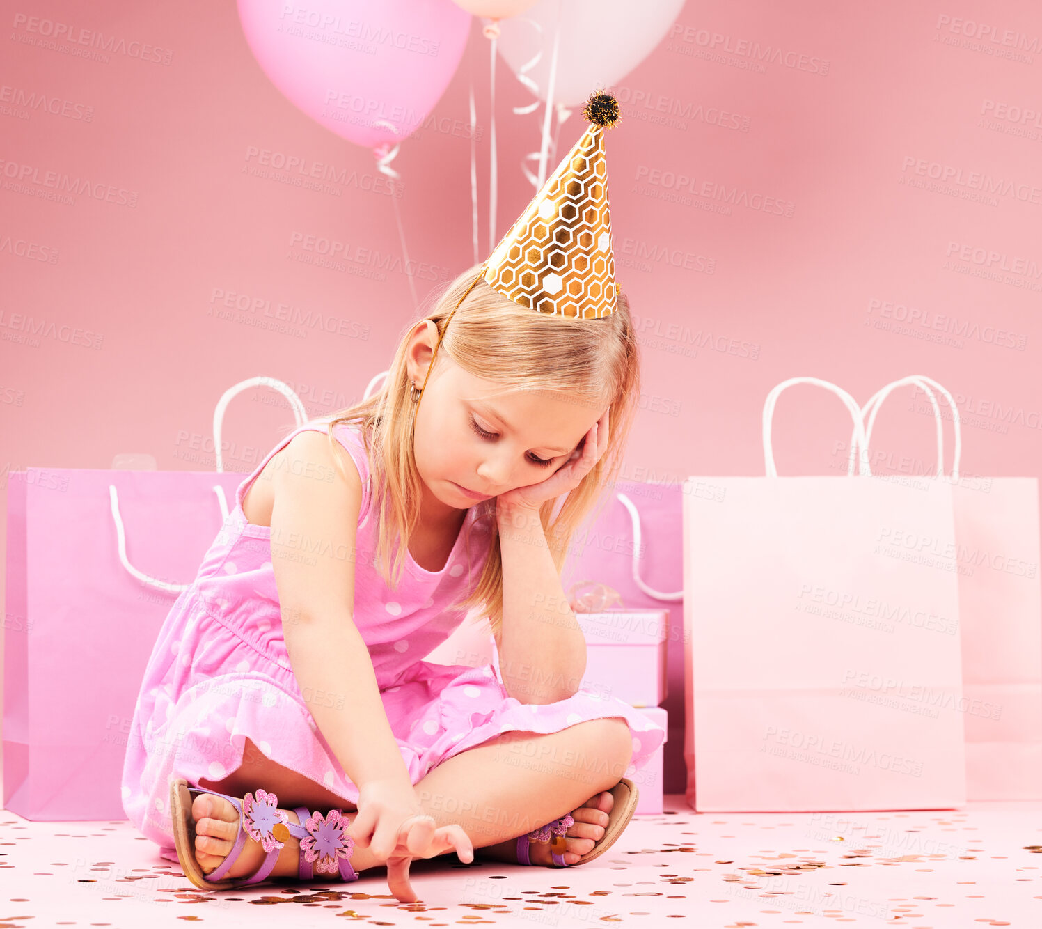 Buy stock photo Depression, sad birthday and child on pink background disappointed for party, celebration and event. Lonely, emotion and unhappy, lonely and upset girl with balloons, presents and gifts in studio