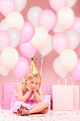 Depression, sad birthday and portrait of girl on pink background for party, celebration and event in studio. Upset, emotion and unhappy, lonely and disappointed child with balloons, presents or gifts