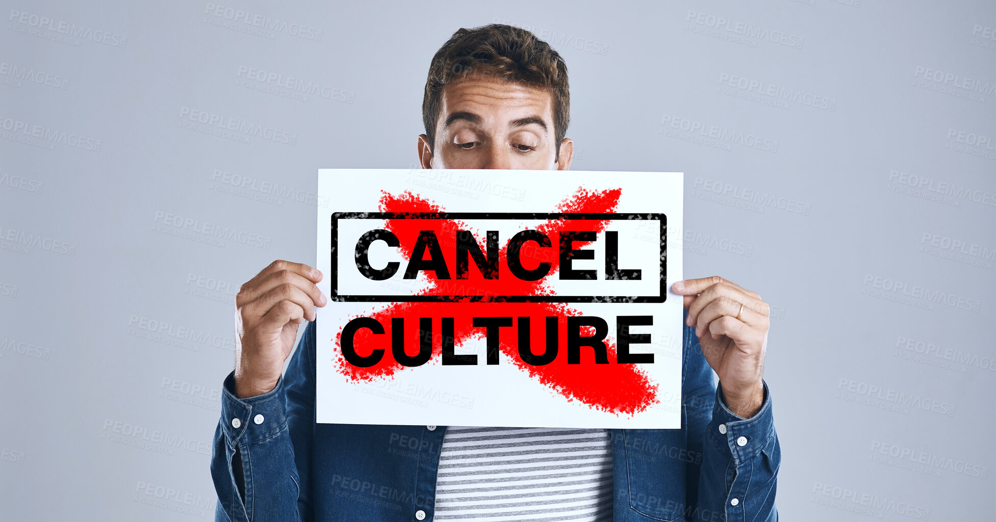 Buy stock photo Cancel culture, person and protest sign in hand with message for social media violence and support in studio. Banner, man and face with mockup space for solidarity and opinion on grey background