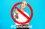 Portrait, rude and cancel culture with a woman on a blue background in studio to reject or deny an icon. Social media, hashtag and censorship with a rebel girl showing a hand gesture in protest