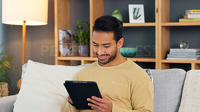 Buy stock photo Relax, smile and asian man with a tablet a sofa for social media, chat or streaming at home. Digital, app and Japanese male in a living room happy for gif, meme or web, post and online communication