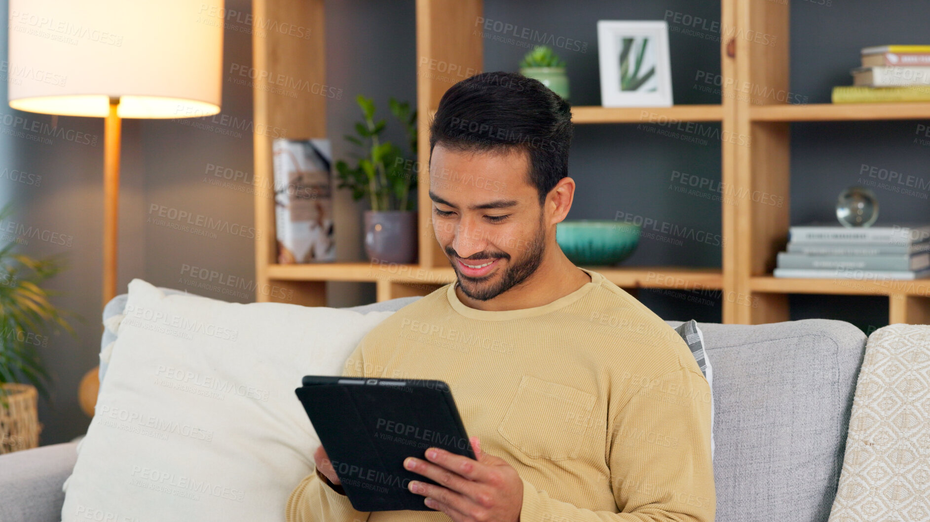 Buy stock photo Relax, smile and asian man with a tablet a sofa for social media, chat or streaming at home. Digital, app and Japanese male in a living room happy for gif, meme or web, post and online communication