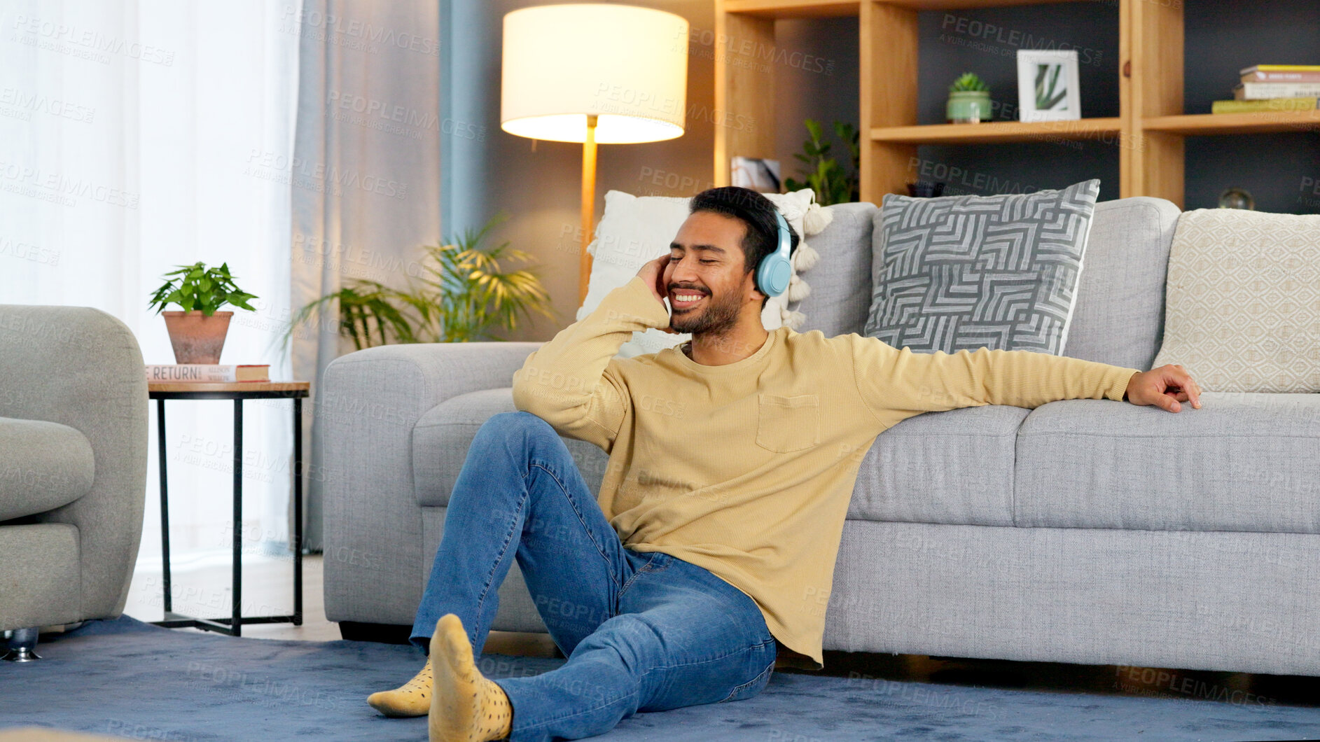 Buy stock photo Man, relax on living room floor and headphone, listening to music with audio streaming, happiness and tech at home. Chill at the weekend, wellness and podcast with sound, connectivity and radio