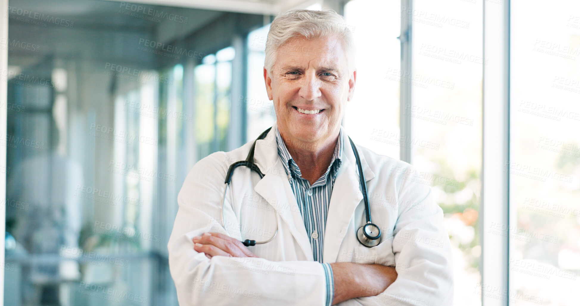 Buy stock photo Doctor in portrait, senior man with arms crossed and healthcare, smile with confidence at hospital with pride and help. Medical professional, trust and expert at clinic with service and medicine