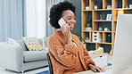 Young woman on computer and talking on phone. Female working alone doing business such as studying research or sending emails at home indoors. Typing seriously then woman is happy to answer mobile