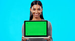 Mockup, green screen and face of a woman with a laptop isolated on a blue background in a studio. Branding, smile and portrait of an Indian girl holding technology with a blank screen for advertising