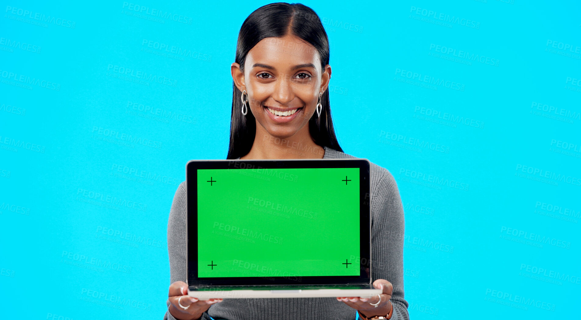 Buy stock photo Portrait, woman and green screen space on laptop for advertising, sign up offer and info in studio. Happy indian model, computer and tracking markers for newsletter, review or deal on blue background