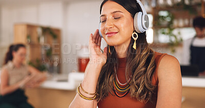 Buy stock photo Music, freelance and woman in coffee shop with headphones, connection and streaming with smile. Relax, technology and remote work, happy girl in cafe listening to audio, radio or motivation podcast.