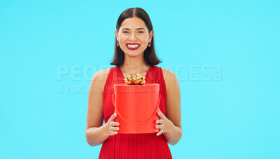 Buy stock photo Birthday present, excited and woman in portrait in studio, celebration and giveaway isolated on blue background. Happiness, smile and winning with gift box, party with reward or bonus prize 