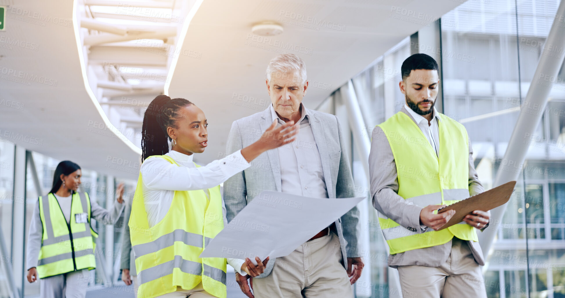 Buy stock photo Engineer, blueprint and talk to business man for architecture, planning and analysis with presentation in hallway. CEO, women or construction worker with pointing, advice or questions for property