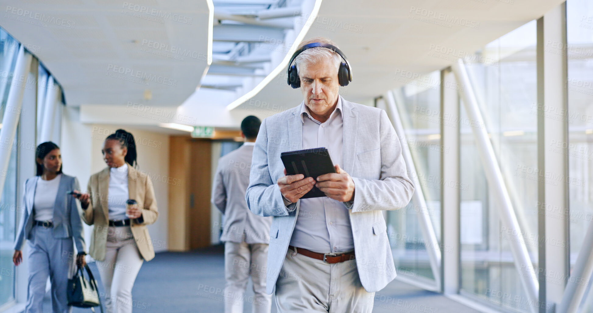 Buy stock photo Business man, headphones and technology, walking and listening to music, video streaming and travel news or podcast. Mature person, executive or boss on bridge and digital tablet or audio electronics