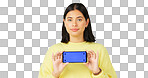 Phone, green screen and dissatisfied woman isolated on studio background for website mockup and tracking marker. Wrong, fail or face of unhappy person with mobile app mock up for advertising space