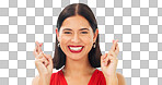 Happy, woman and face with fingers crossed on blue background, studio and wishing for good luck. Portrait of excited female model hope for winning prize, optimism and smile for emoji, hands and sign