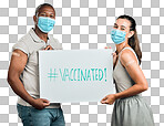 Covid vaccinated African american man and mixed race woman showing and holding poster. Two people wearing surgical face mask isolated on red studio background with copyspace. Promote corona vaccine