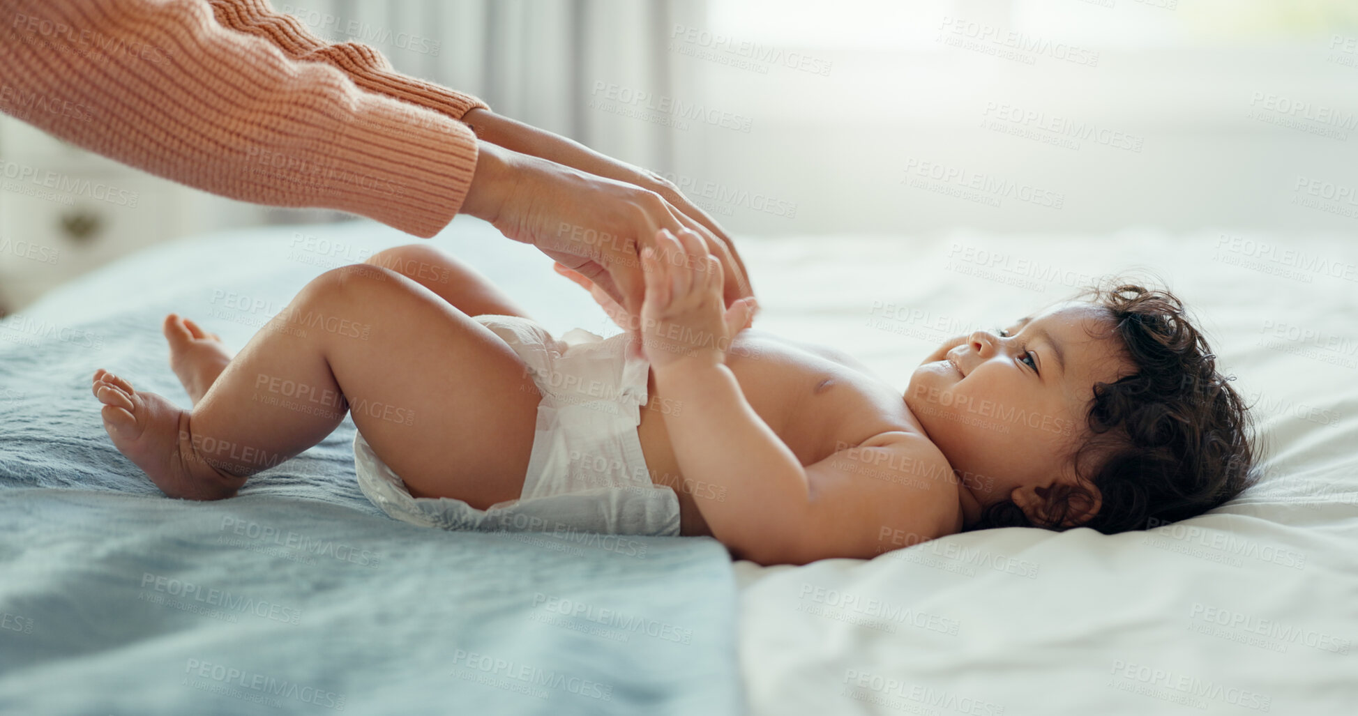 Buy stock photo Hands, family and a baby on a bed with a parent in the home together for trust, care or bonding closeup. Love, kids or security with an adult and infant child in the bedroom of a house for growth