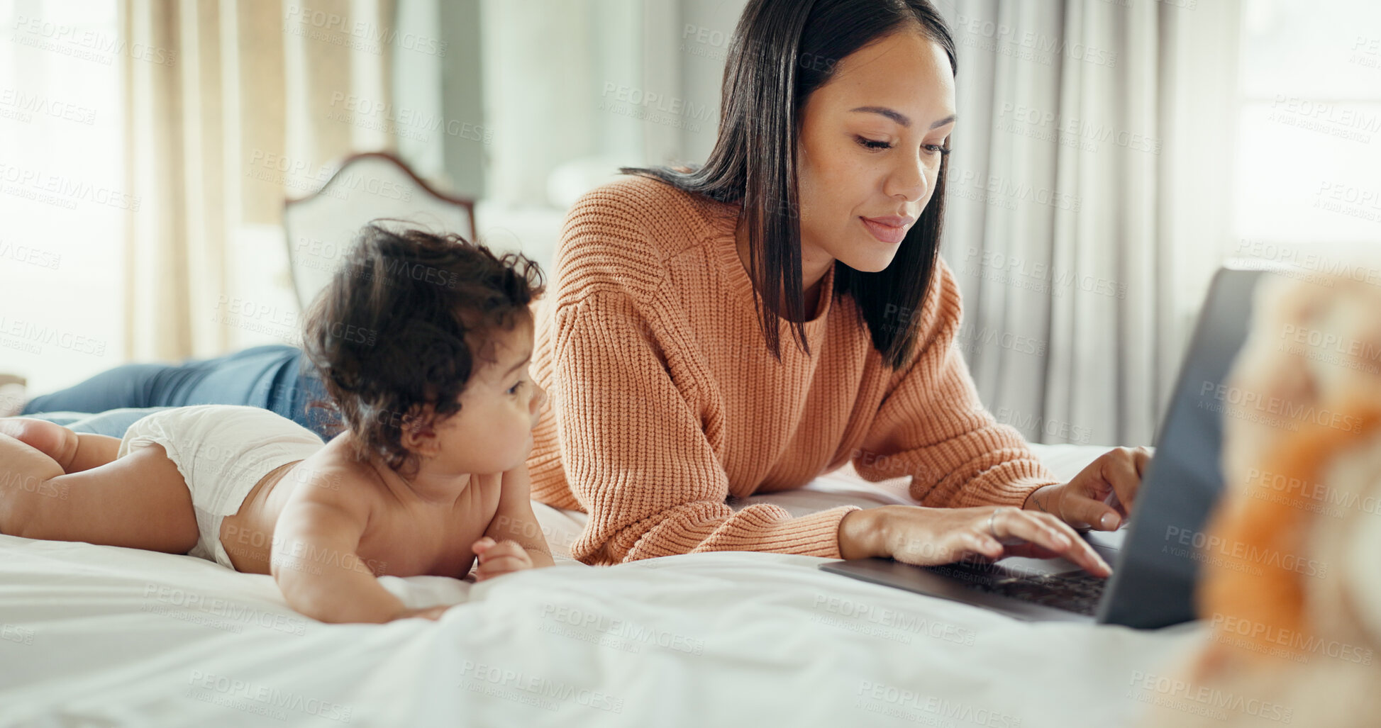 Buy stock photo Parent, laptop and mom working with baby on a bed for remote work and babysitting in home bedroom. Serious, online and mother typing with newborn or infant while writing a blog on website or internet