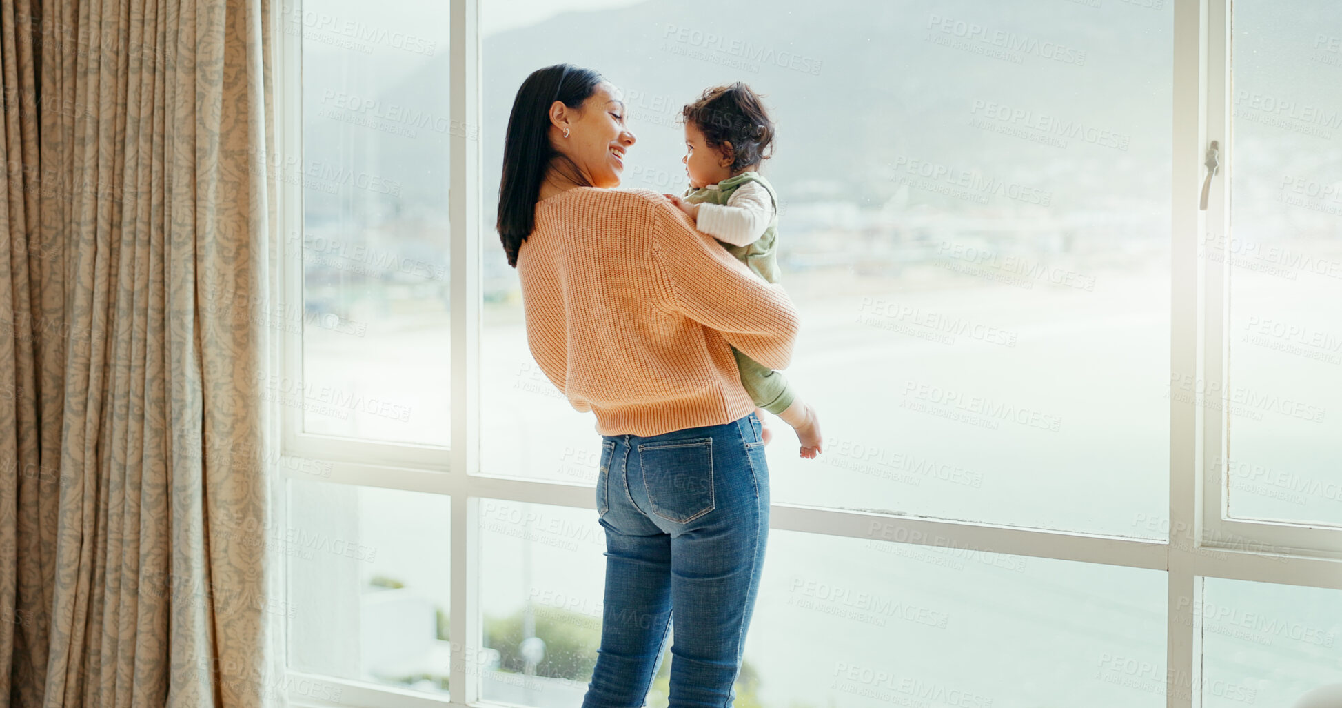 Buy stock photo Mom, love and baby at window in home, living room and relax with beach, view and ocean landscape. Smile, hug and mother bonding with child in the morning with care and support together in sunshine