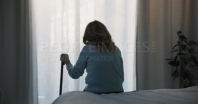 Thinking, sad and window with old woman and walking stick in bedroom for wellness, retirement and healthcare. Depression, mental health and nursing home with patient with a disability for support