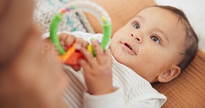 Buy stock photo Sweet, playing and cute baby with a toy on a blanket for child development, fun and entertainment. Happy, adorable and playful infant child relaxing on a bed in his nursery or bedroom at family home.