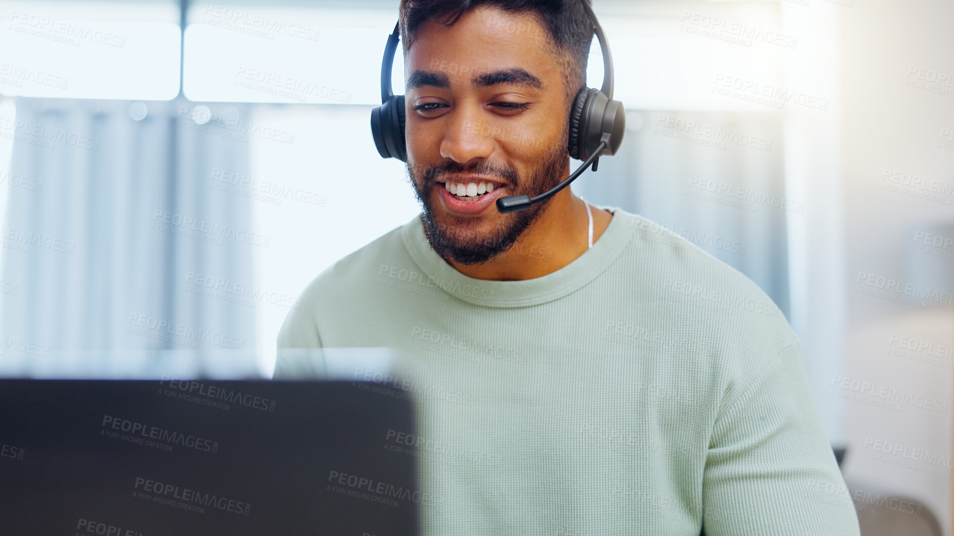 Buy stock photo Video call, black man and work from home, virtual communication or remote client tech support in call center career. Hello, wave of indian person, agent or consultant in living room on laptop talking