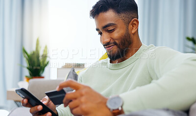 Buy stock photo Credit card, finance and man with smartphone for online shopping in lounge at home. Indian, visa and money for e commerce transaction and search the internet for investment or product.