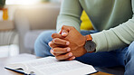 Prayer, worship and bible with hands of person in living room for peace, spiritual and Christian. Hope, God and belief with closeup of man with holy book at home for religion, praying and gratitude