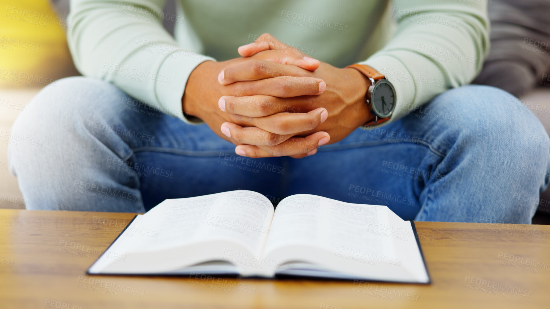 Buy stock photo Prayer, peace and bible with hands of person in living room for worship, spiritual and Christian. Hope, God and belief with closeup of man with holy book at home for religion, praying and gratitude