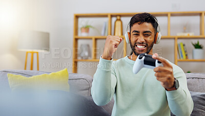 Gaming, winner success and esports with a man in the living room of his home, playing a video game for fun. Winning, celebration and next level with a gamer using a joystick controller to play console games
