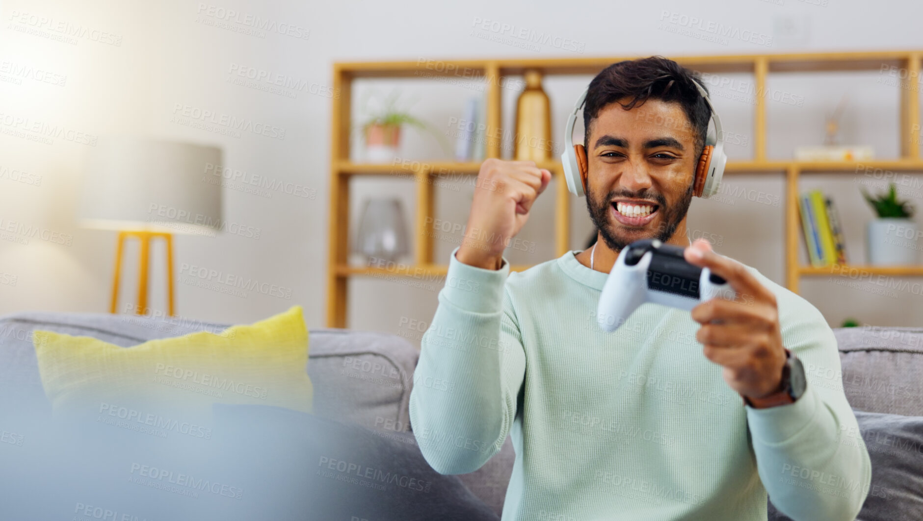 Buy stock photo Gaming, winner success and esports with a man in the living room of his home, playing a video game for fun. Winning, celebration and next level with a gamer using a joystick controller to play console games