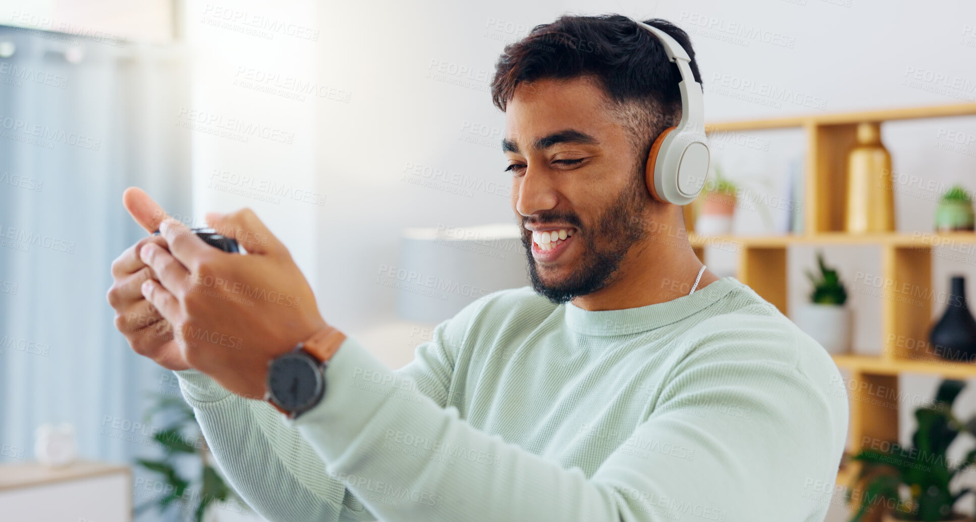 Buy stock photo Indian man with smartphone, headphones and face, music and smile, scroll social media and audio streaming. Online, listening to radio or podcast with happiness and relax with texting or email