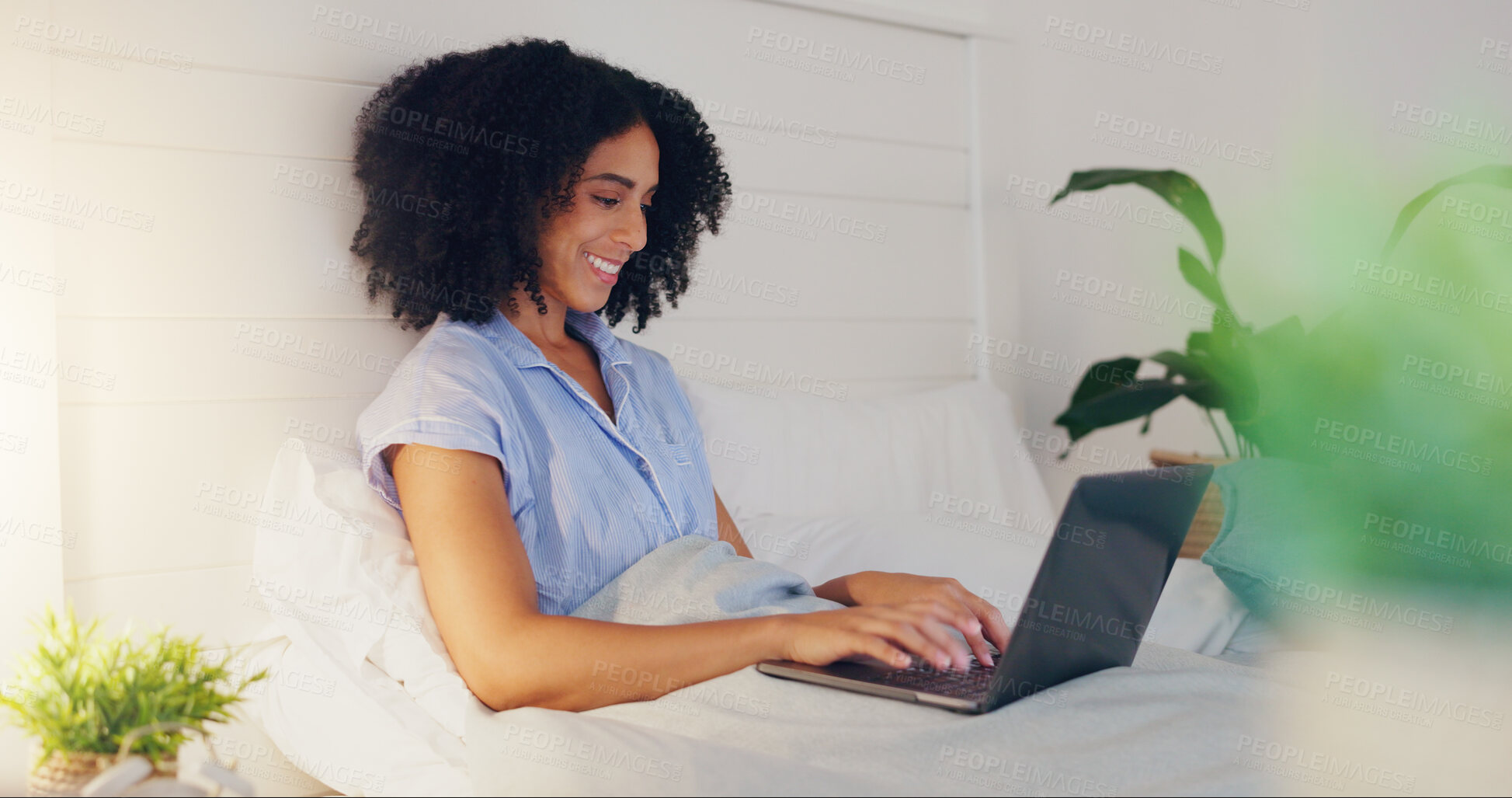 Buy stock photo Blog writer typing with laptop for internet streaming website and reading funny social media post in bed at home. Woman freelance worker in bedroom working remote while writing funny or comic web content, series or movie.