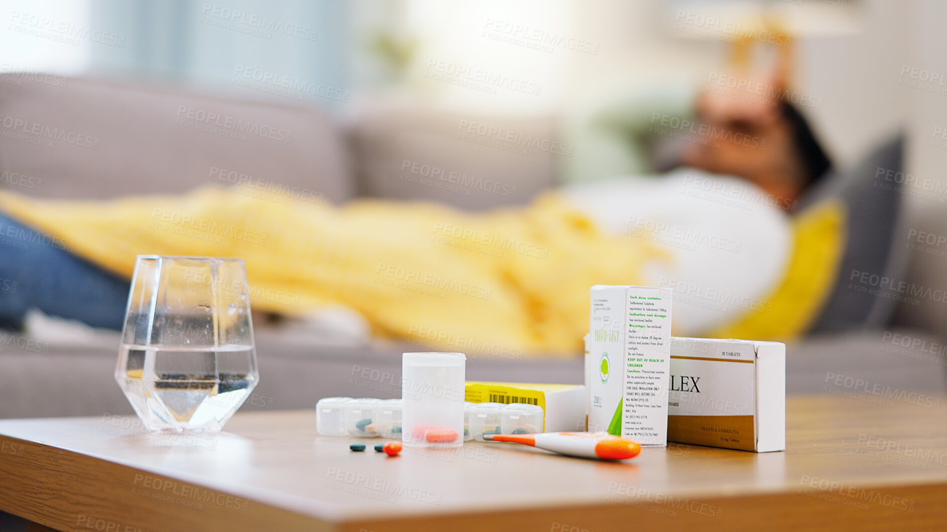 Buy stock photo Medicine, sick and man on the sofa with pills for an allergy, virus or cold. Healthcare, covid and African male on the couch with medication for a flu, disease or antibiotics for an illness