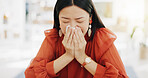 Tissue, blowing nose and sick Asian woman in office with sinus infection, virus and allergy symptoms. Business, corporate workplace and female worker at desk with cold, fever problem and flu sickness