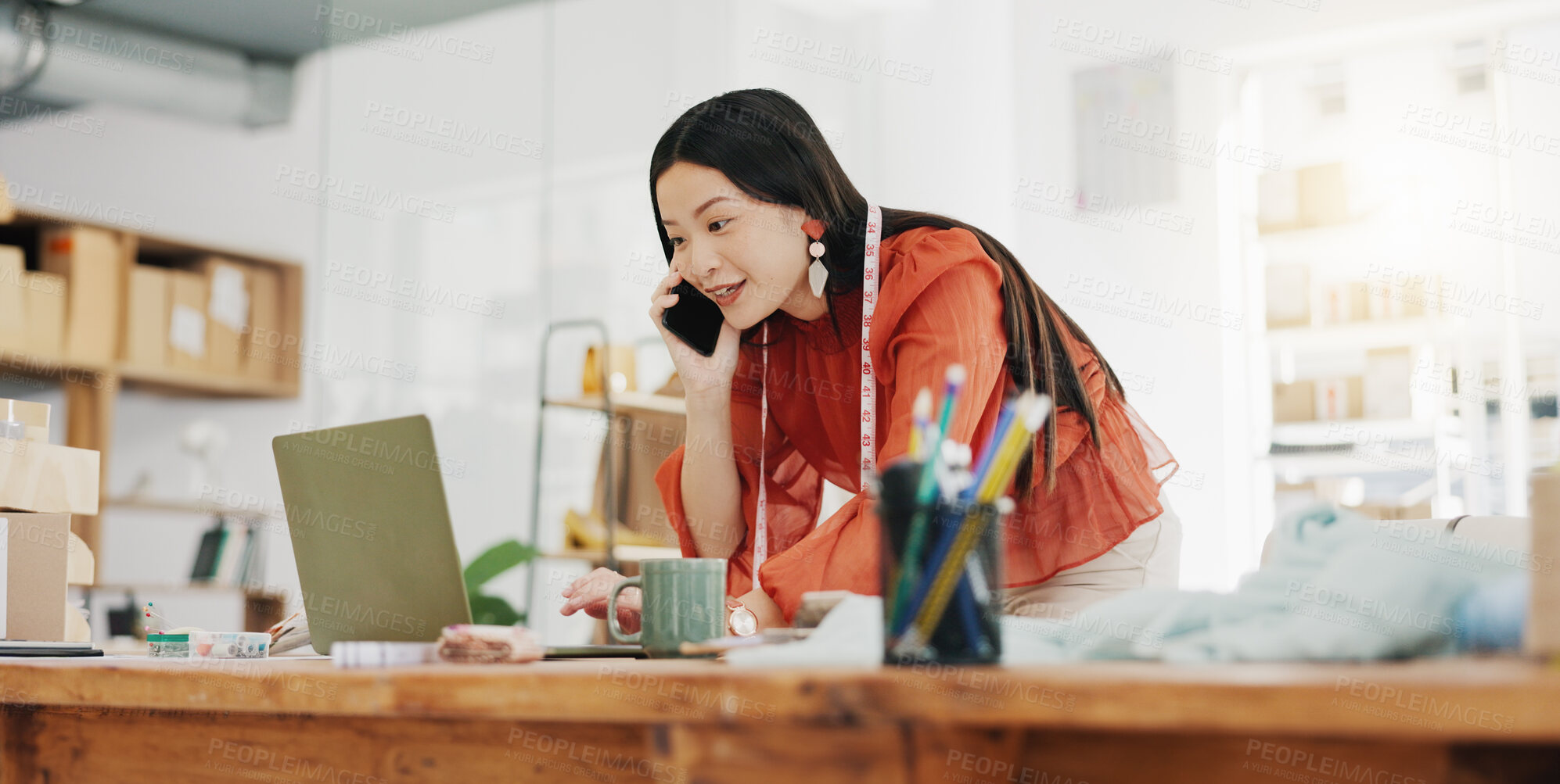 Buy stock photo Phone call, laptop and creative with a designer asian woman at work in her fashion office for a style order. Contact, ecommerce and design with a female employee talking on her phone for retail