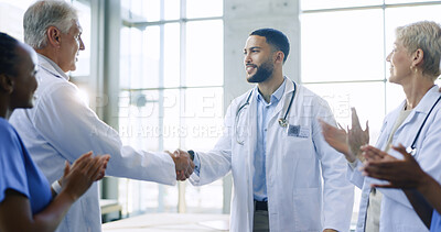 Meeting, applause or doctors shaking hands for success, good job or promotion in a hospital clinic. Group clapping, congratulations or proud healthcare worker with handshake for teamwork or thank you