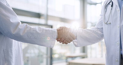 Hands, teamwork or doctors shaking hands for success, good job or promotion goal in a hospital meeting. Closeup, congratulations or proud healthcare worker with handshake for medical collaboration