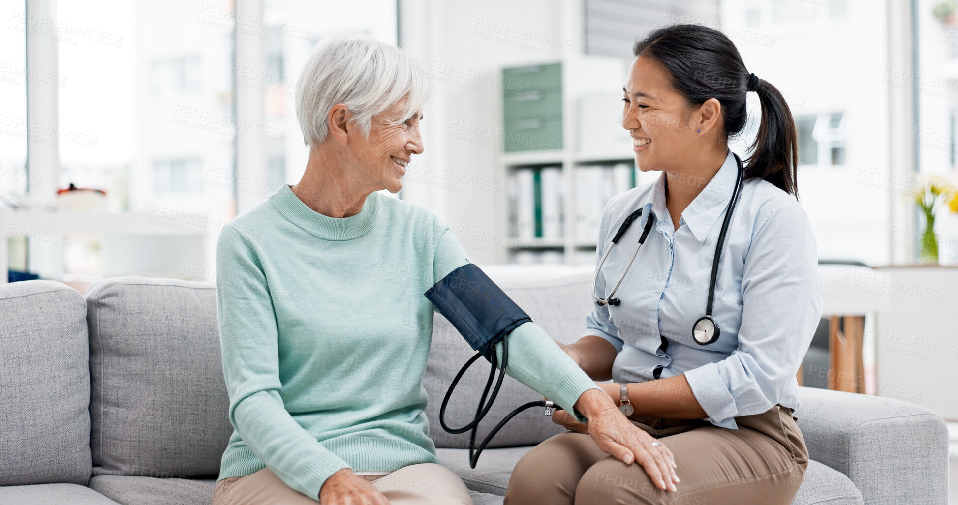 Buy stock photo Doctor, senior patient and blood pressure check with consultation, talking and help, health in hospital office. Women at clinic, communication and cardiovascular healthcare, elderly care and support