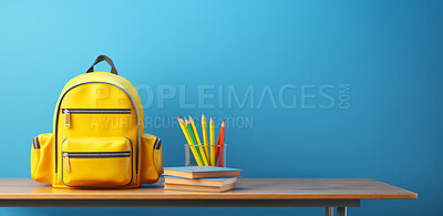 Buy stock photo Backpack, books, and pencils on table on blue copyspace background