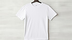 White t-shirt mockup with copyspace on dark background on hanger, front view